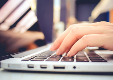 Female Hands Typing On Keyboard Of Laptop